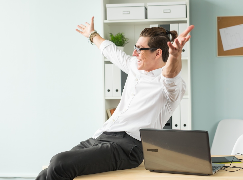 Handsome businessman having fun in the office distributori